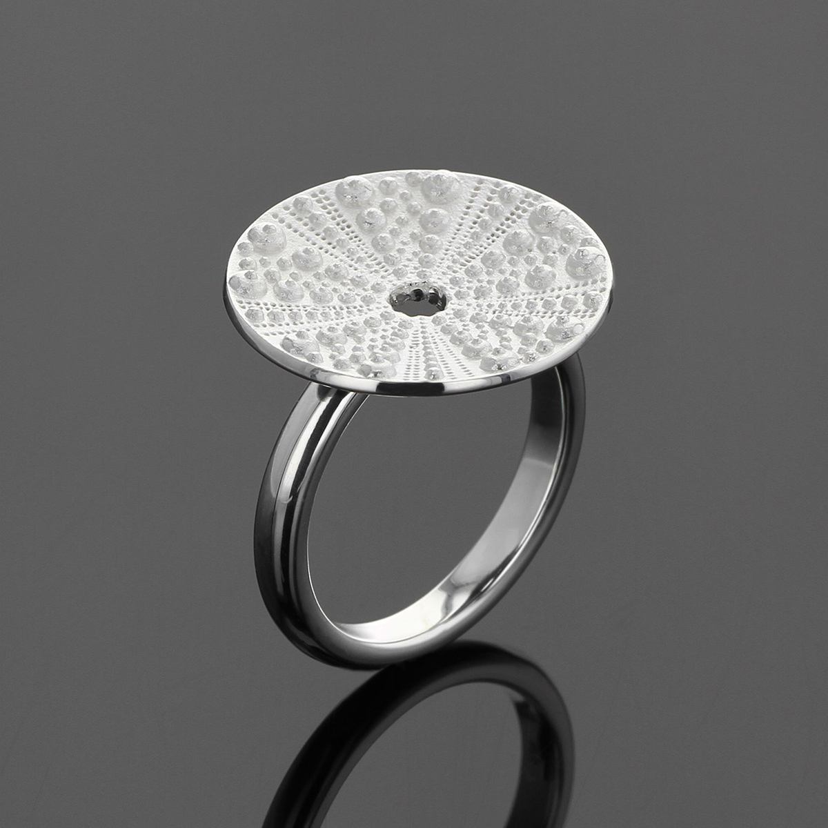 Silver ring with sea urchin texture.