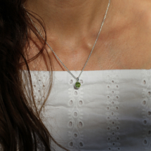 Small and simple pendant in polished sterling silver with a bubble shaped light green stone.