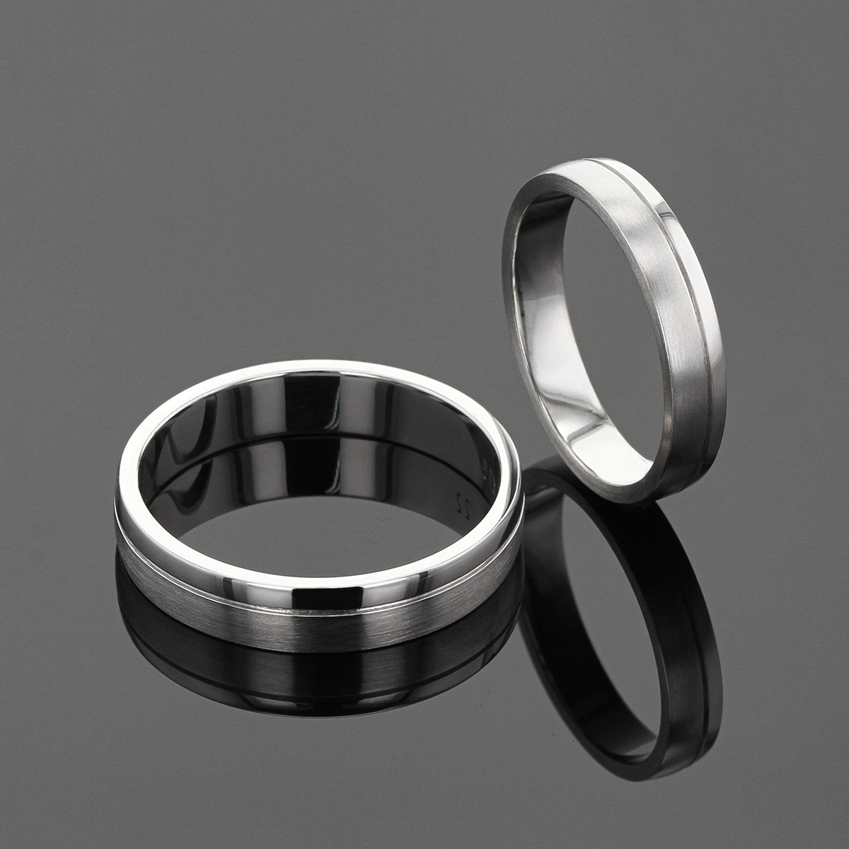 Classic wedding bands in white gold with a fine line that seperates a third of each ring in a matted finish to the contrasting one third in a polished finish.