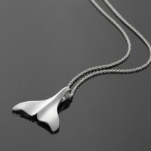 Whale fin pendant in sterling silver on a chain.