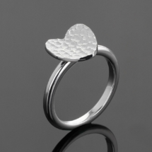 Silver heart shaped ring with a lava texture