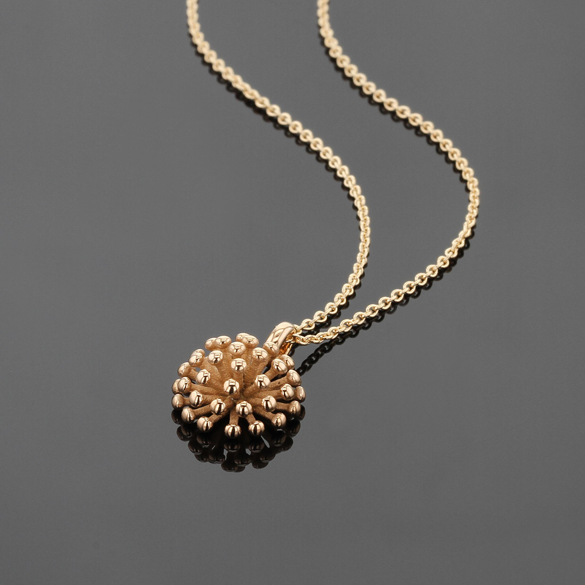 18ct rose gold pendant in the form of a dandelion flower.