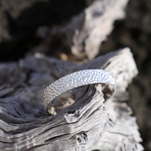 Wide bangle in sterling silver adorned with a lava inspired texture