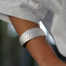 Wide silver bangle with a rock texture