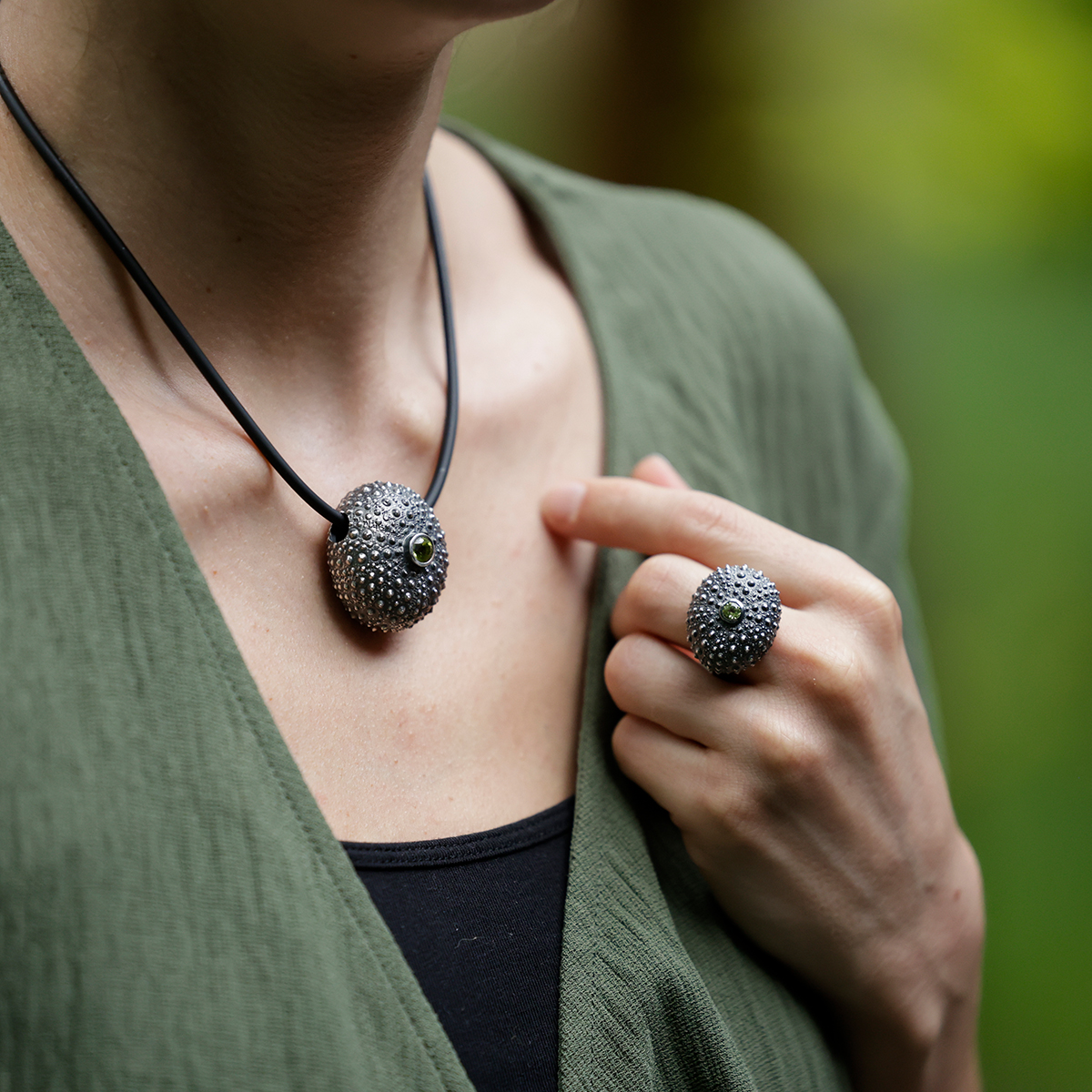 Sea urchin ring in black silver with a Peridot stone along with its matching pendant