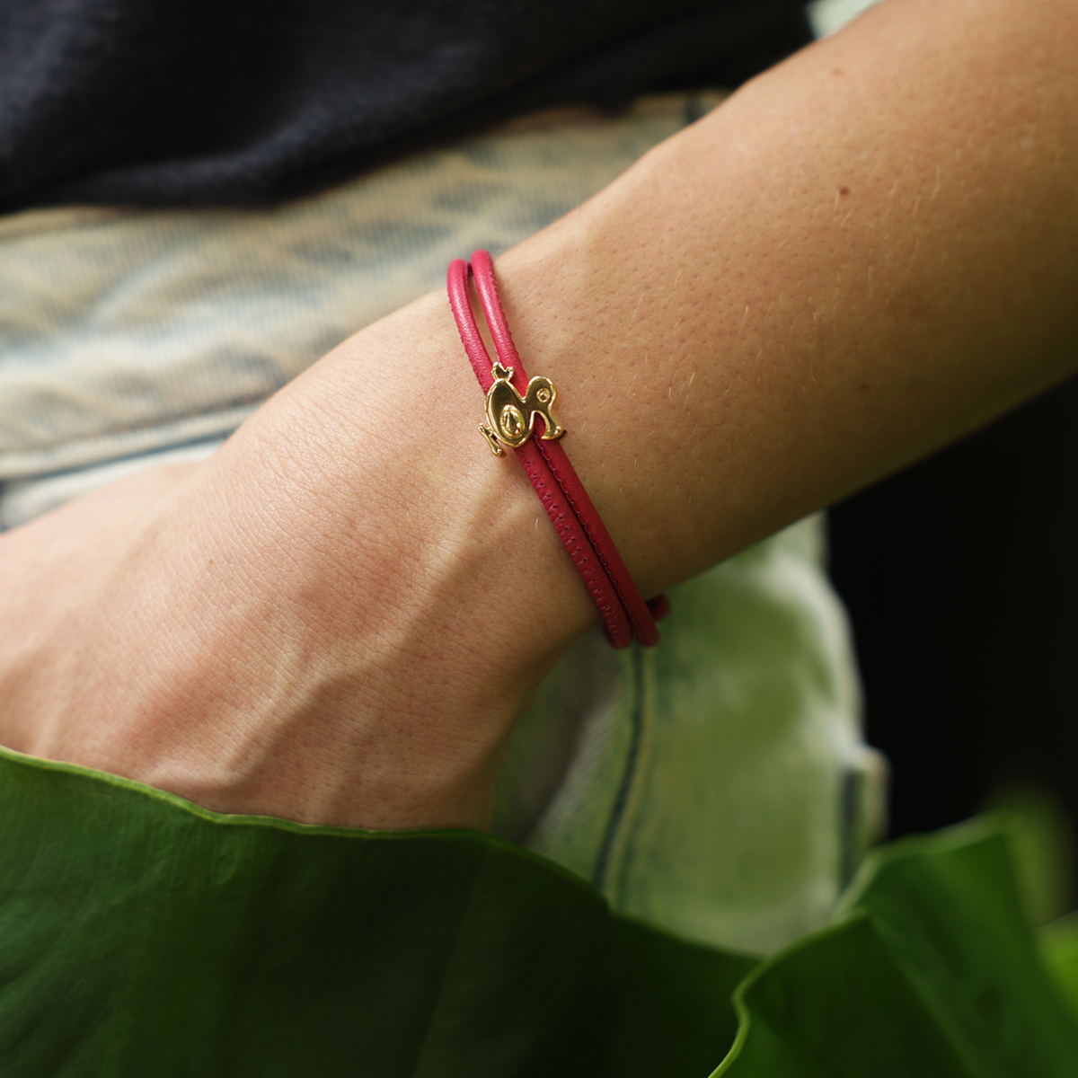 rose gold dodo charm on a red leather bracelet