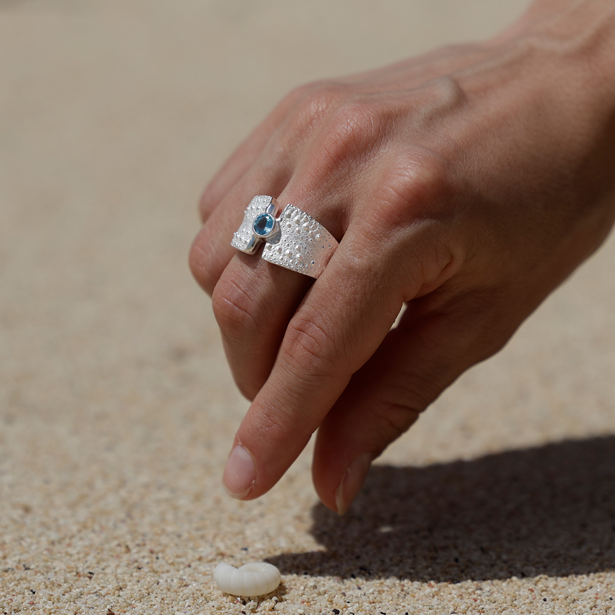 Silver ring with a sea urchin texture and Blue Topas stone