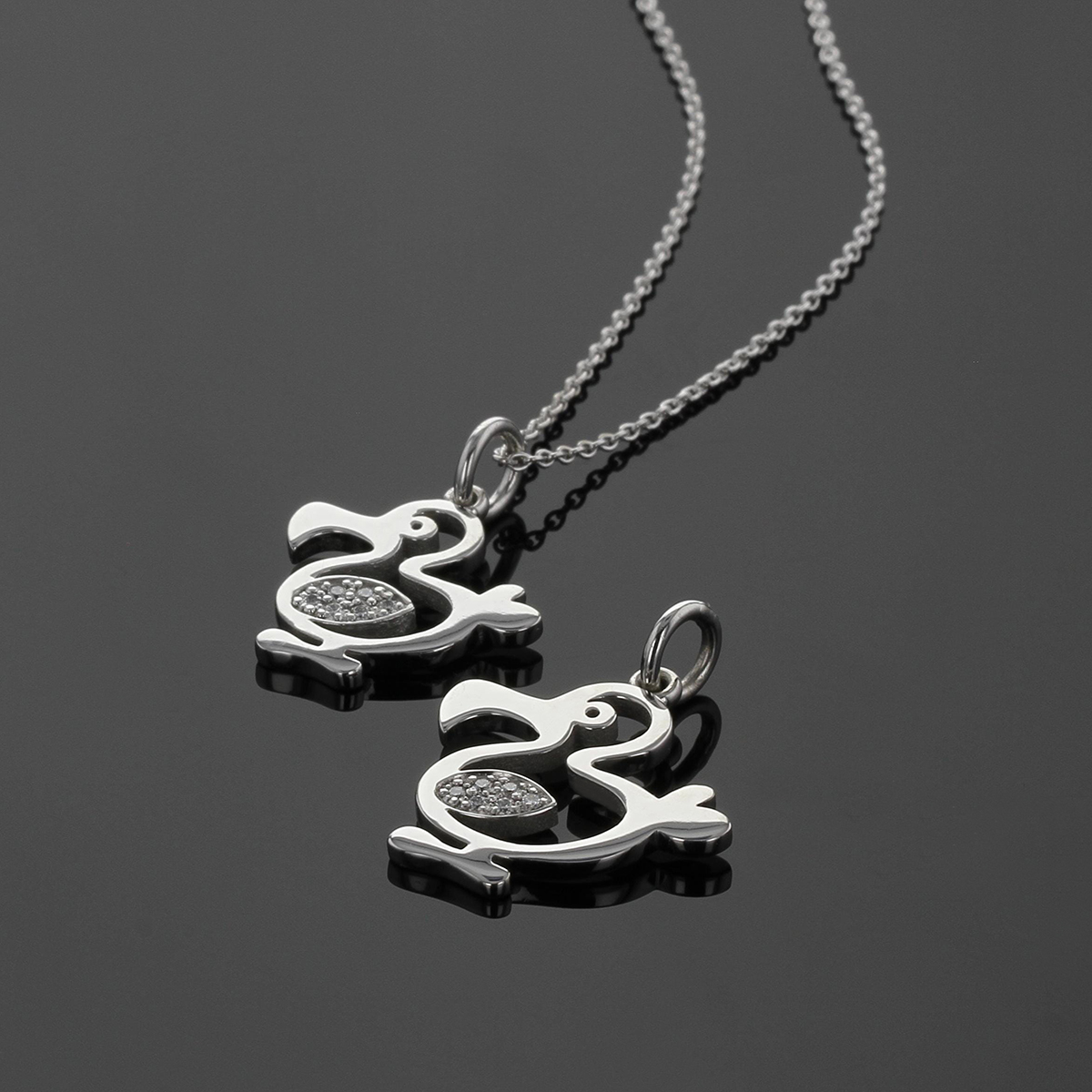 Dodo pendants in polished white gold with diamonds set in their wings