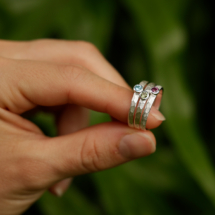 Tiny silver rings with a light rock texture and precious stones