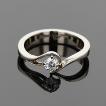 Polished white gold engagement ring with a diamond