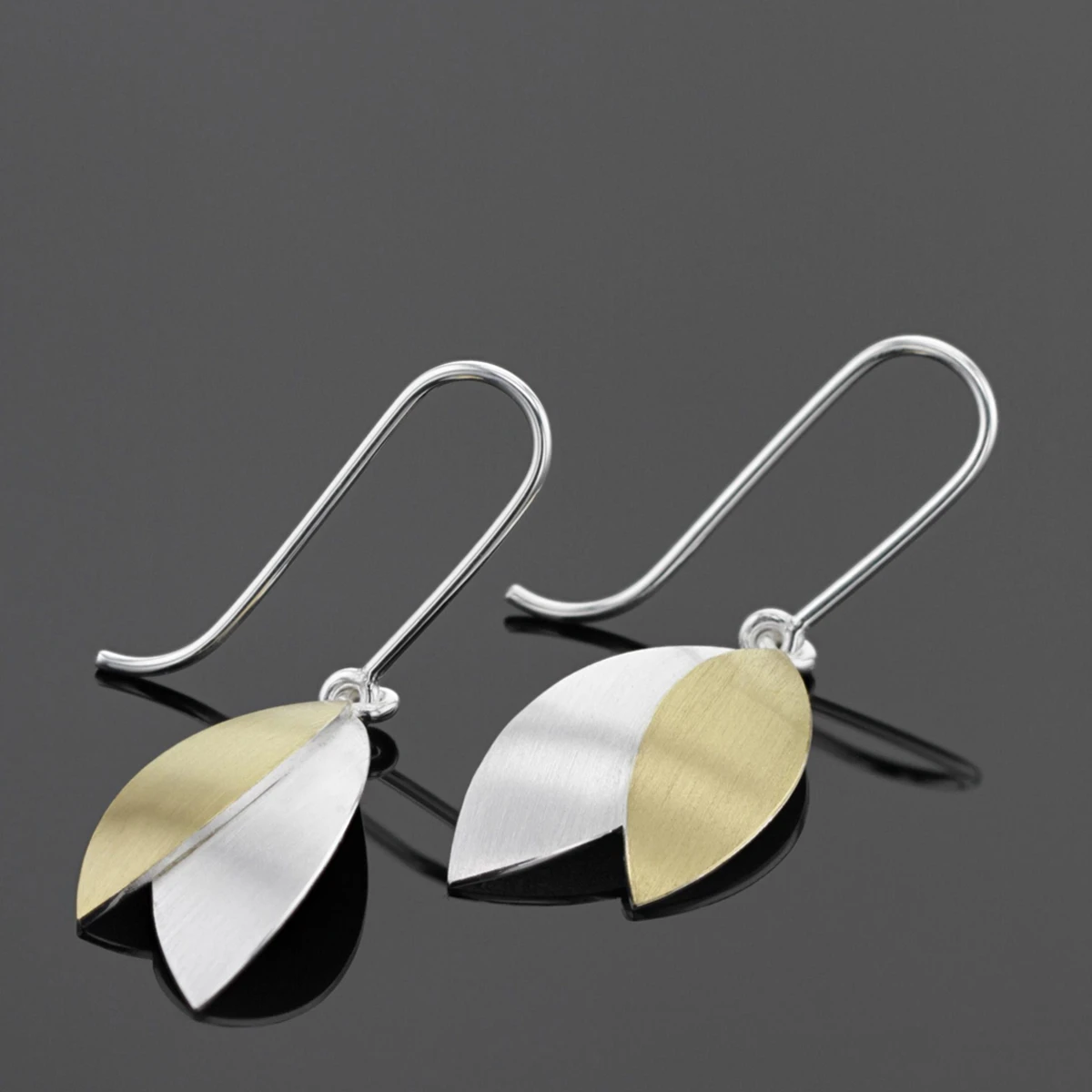 Leaf shaped earrings in silver with gold