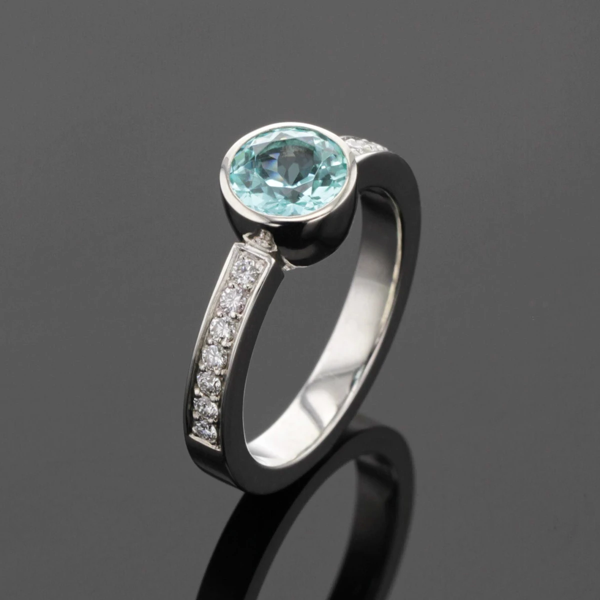 White gold ring with diamonds and a Paraiba