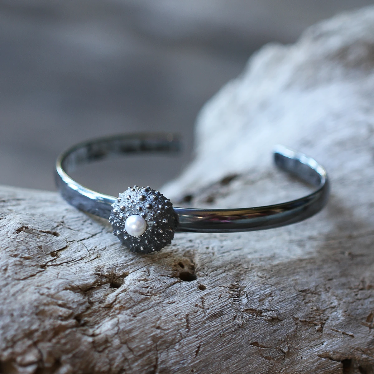 Black silver bangle with a freshwater pearl and sea urchin element