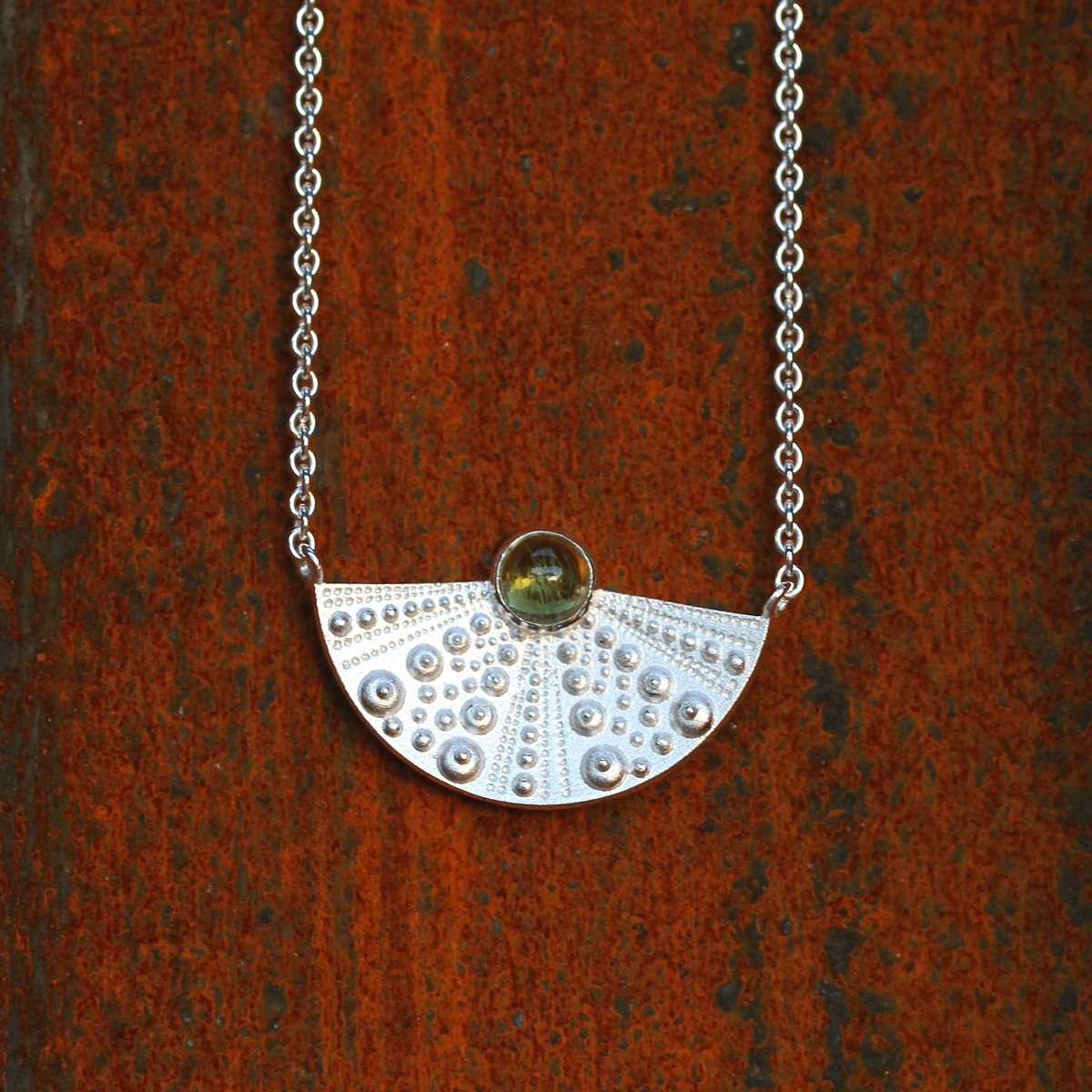 Silver sea urchin collier with a Peridot cabochon