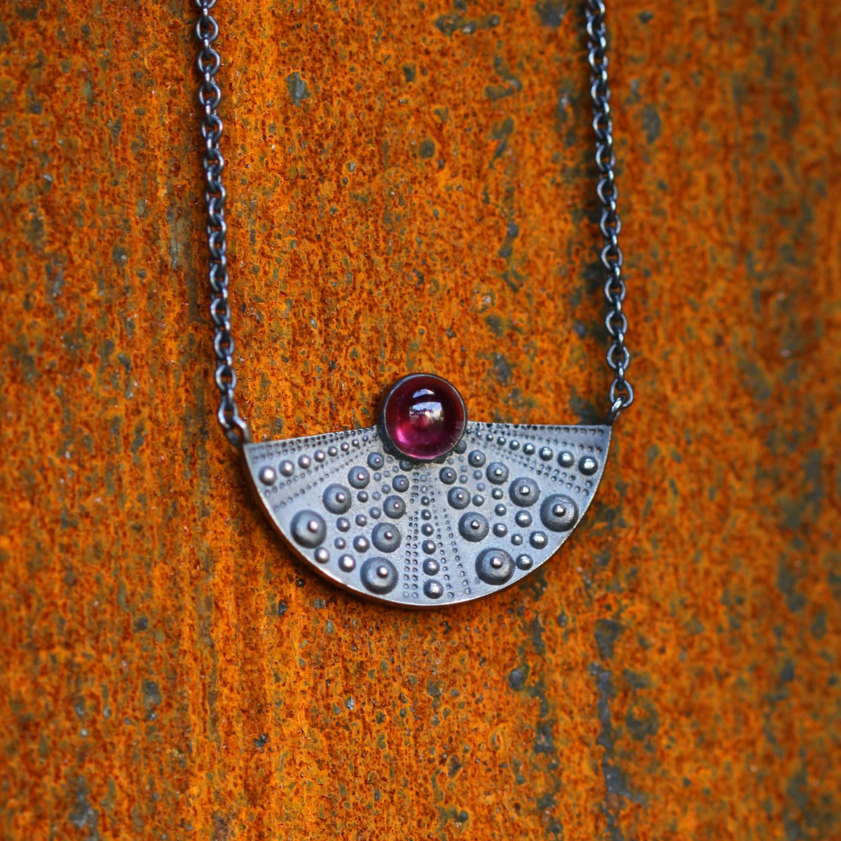 Black silver sea urchin collier with a Rhodolite