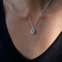 Polished silver pendant with a Blue Topas and yellow gold setting