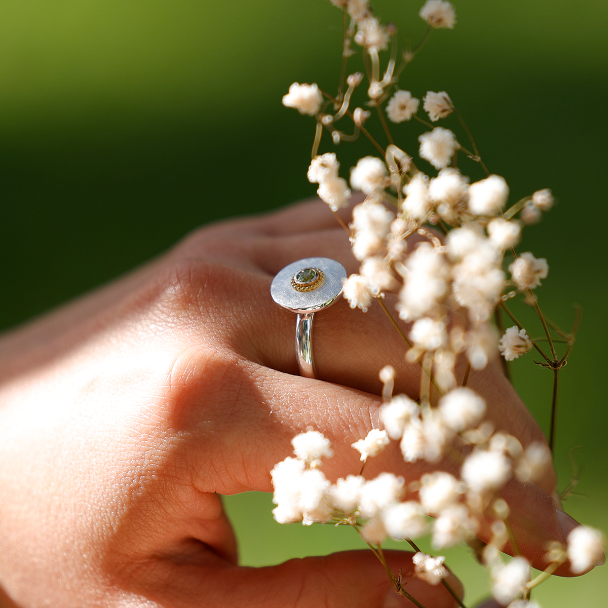 Silver and gold ring with a Peridot