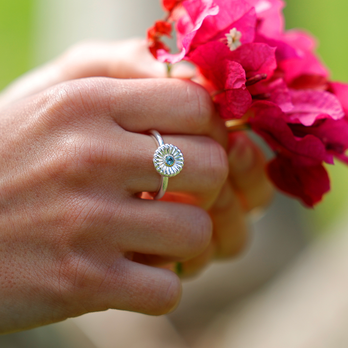 Polished silver ring with a precious stone and gold setting