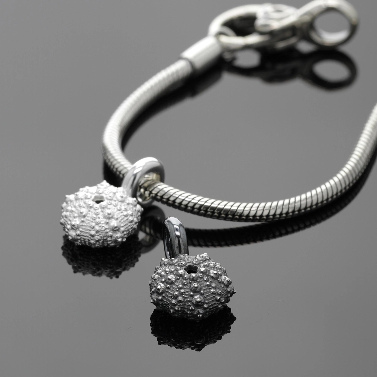 Sea urchin charms in oxidised and naural sterling silver