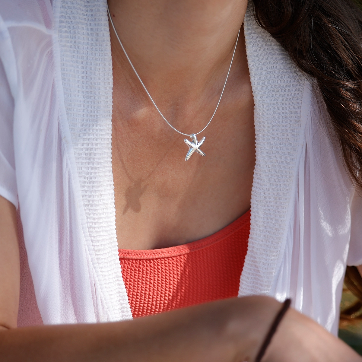 Small seastar pendant in polished silver.